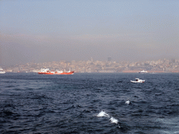 The Beyoglu district with the Galata Tower and boats in the Bosphorus strait, viewed from the ferry