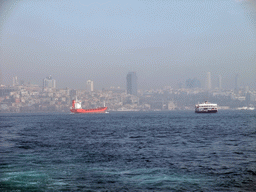 Skyline of the Beyoglu district, with the Dolmabahce Mosque and boats in the Bosphorus strait, viewed from the ferry