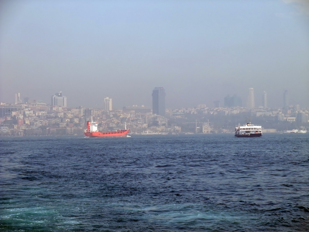 Skyline of the Beyoglu district, with the Dolmabahce Mosque and boats in the Bosphorus strait, viewed from the ferry