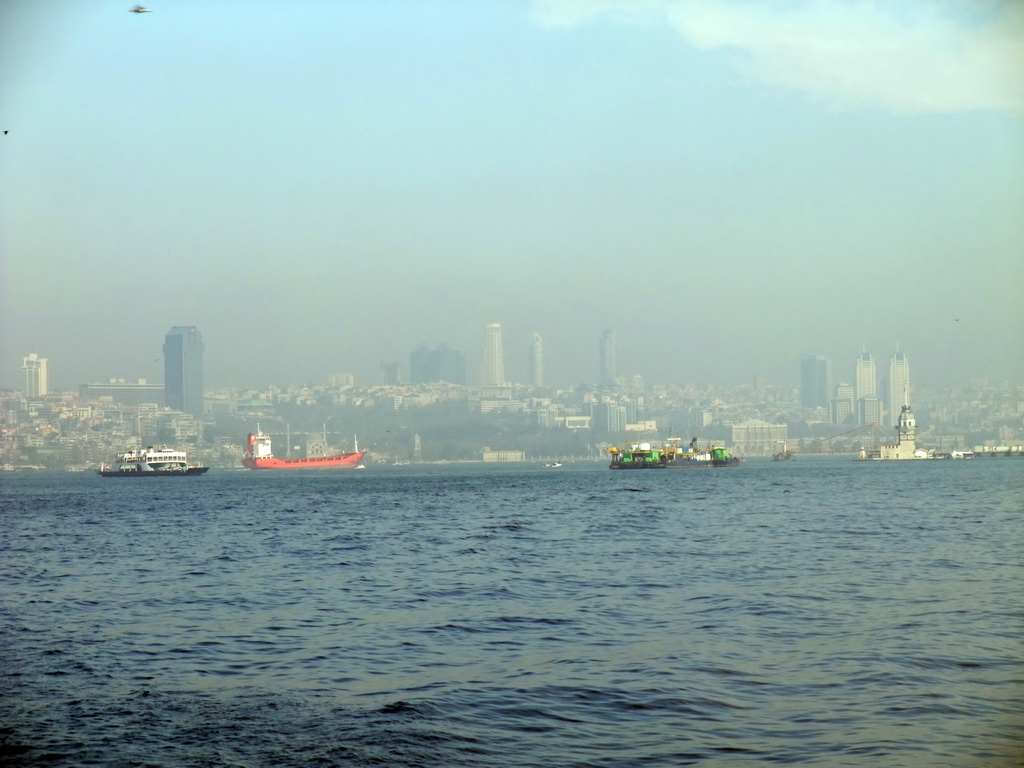 Skyline of the Beyoglu district with the Dolmabahce Mosque, the Maiden`s Tower and boats in the Bosphorus strait, viewed from the ferry