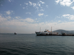 Boat in the harbour of Heybeliada island, with Büyükada island on the background
