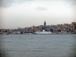 The Beyoglu district with the Galata Tower and boats in the Bosphorus strait, viewed from the ferry
