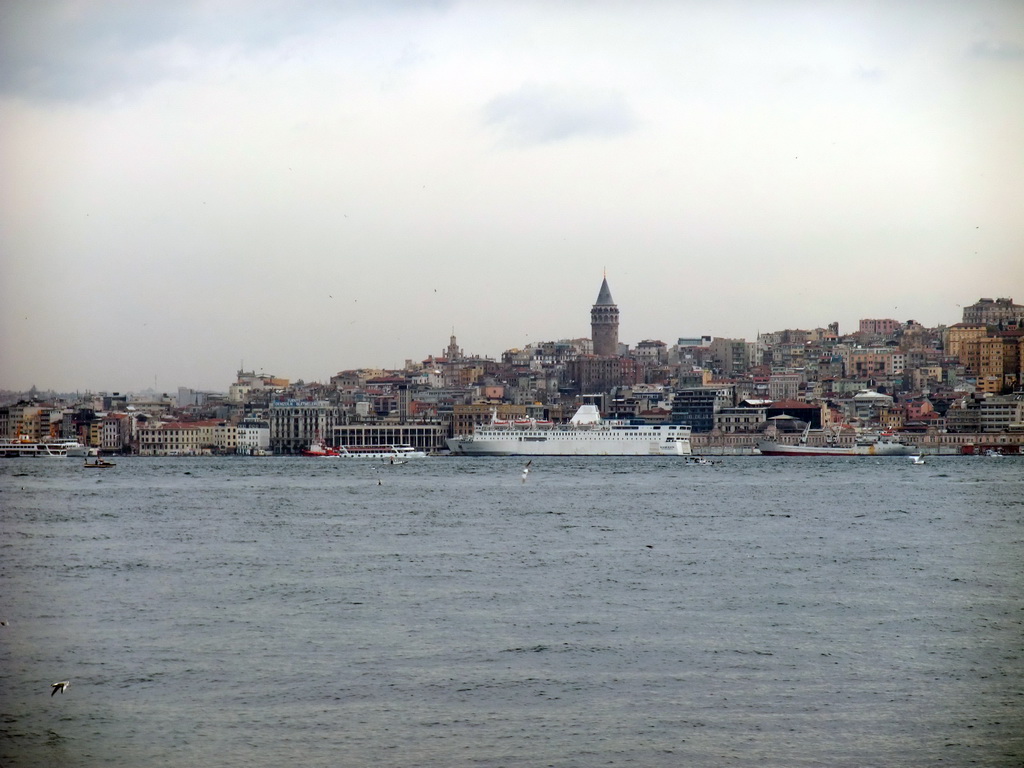 The Beyoglu district with the Galata Tower and boats in the Bosphorus strait, viewed from the ferry