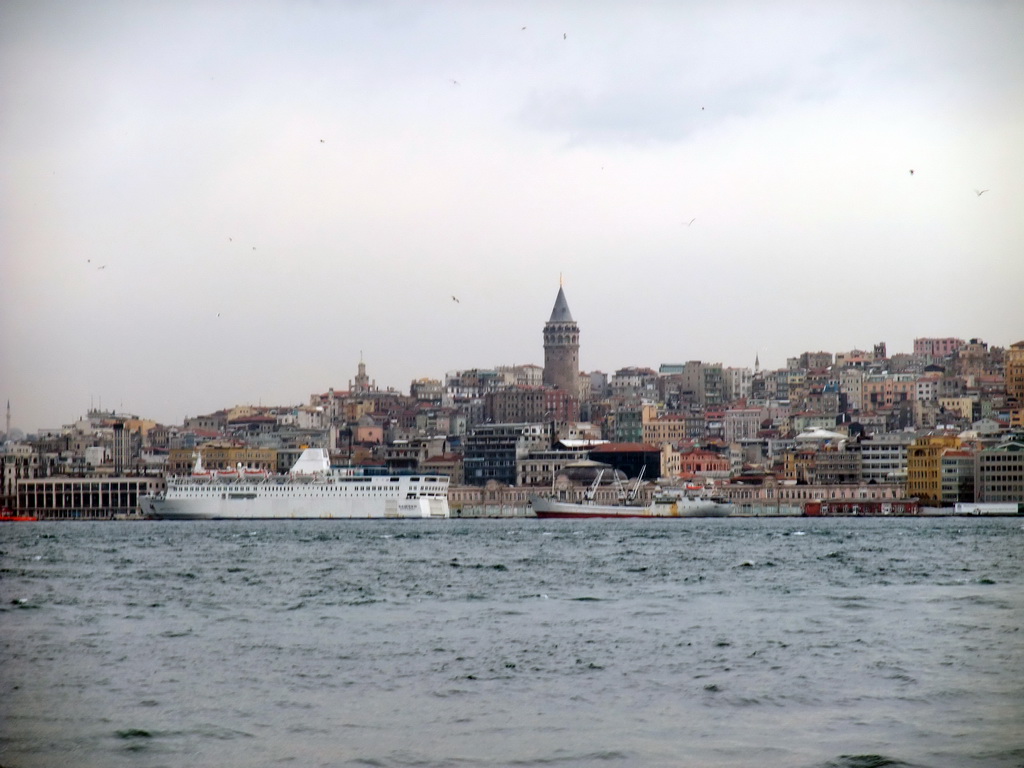 The Beyoglu district with the Galata Tower and boats in the Bosphorus strait, viewed from the ferry