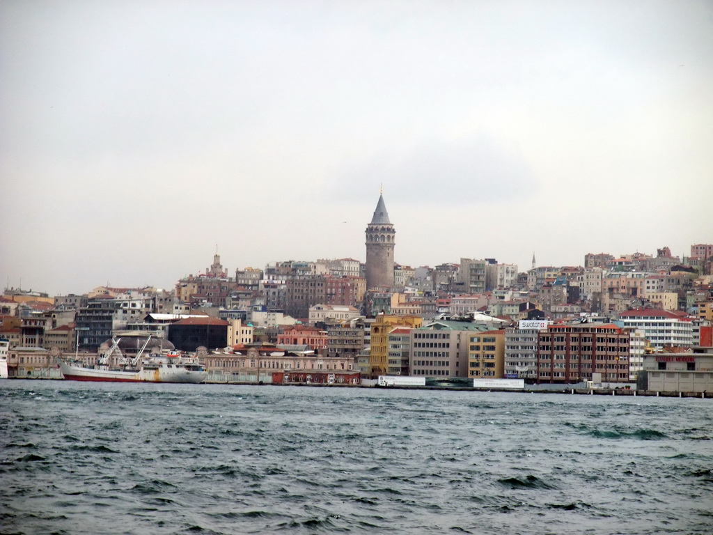 The Beyoglu district with the Galata Tower and a boat in the Bosphorus strait, viewed from the ferry