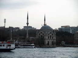 The Dolmabahce Mosque and boats in the Bosphorus strait, viewed from the ferry