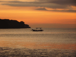 Boat in Jimbaran Bay, viewed from Jimbaran Beach, at sunset