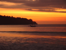Boat in Jimbaran Bay, viewed from Jimbaran Beach, at sunset