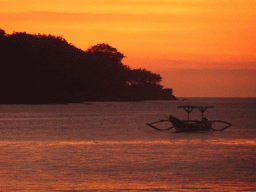 Boat in Jimbaran Bay, viewed from Jimbaran Beach, at sunset