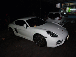 Porsche in front of the Fat Chow Temple Hill restaurant at the Jalan Raya Uluwatu street, by night