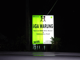 Sign of the Iiga Warung restaurant at the Jalan Raya Uluwatu street, by night