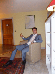 Tim with a glass of wine in a chair at the second floor of the Château de Beauregard castle