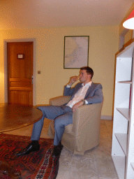 Tim with a glass of wine in a chair at the second floor of the Château de Beauregard castle