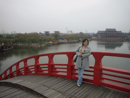 Miaomiao with candy on a bridge at Qingming Shanghe Park