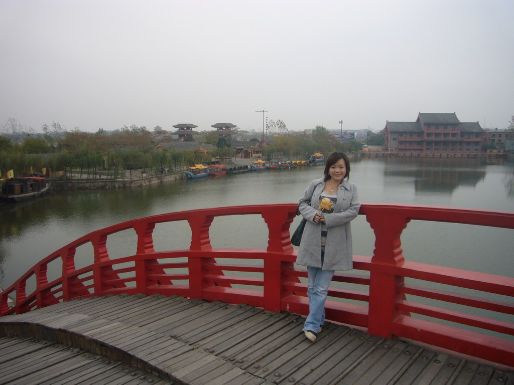 Miaomiao with candy on a bridge at Qingming Shanghe Park