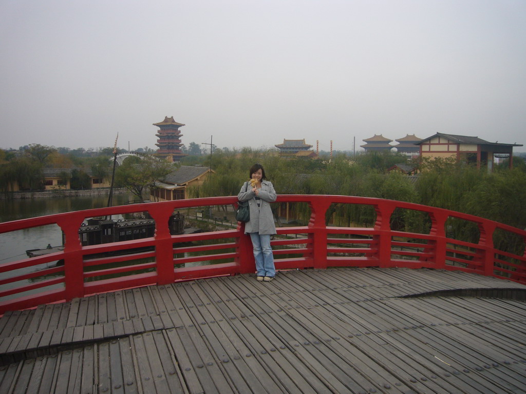 Miaomiao with candy on a bridge at Qingming Shanghe Park