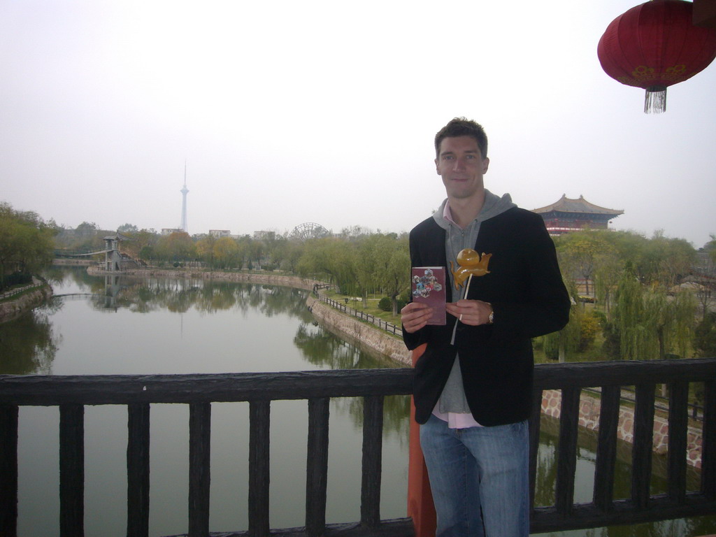 Tim with candy and map on a bridge at Qingming Shanghe Park