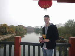 Tim with candy and map on a bridge at Qingming Shanghe Park