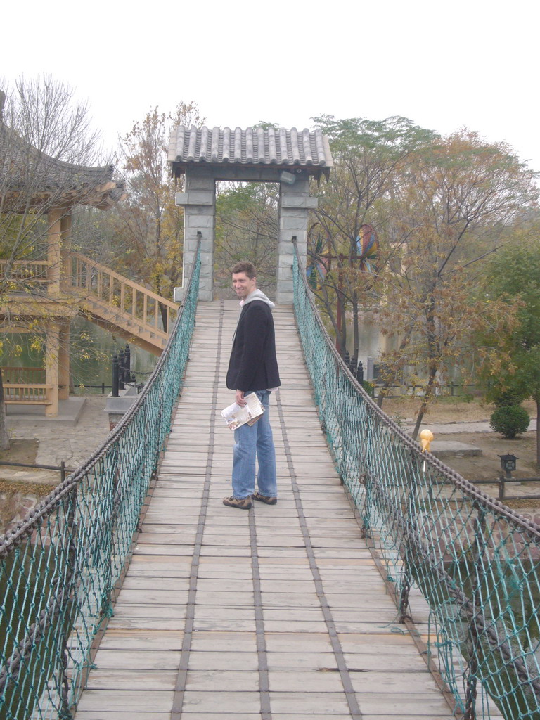 Tim on a suspension bridge at Qingming Shanghe Park