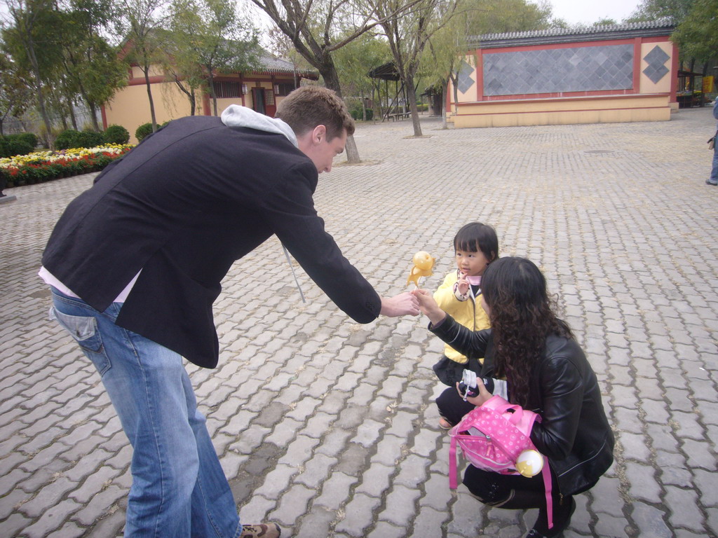 Tim giving candy to child at Qingming Shanghe Park