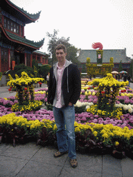 Tim with flowers at the entrance of Youguo Temple