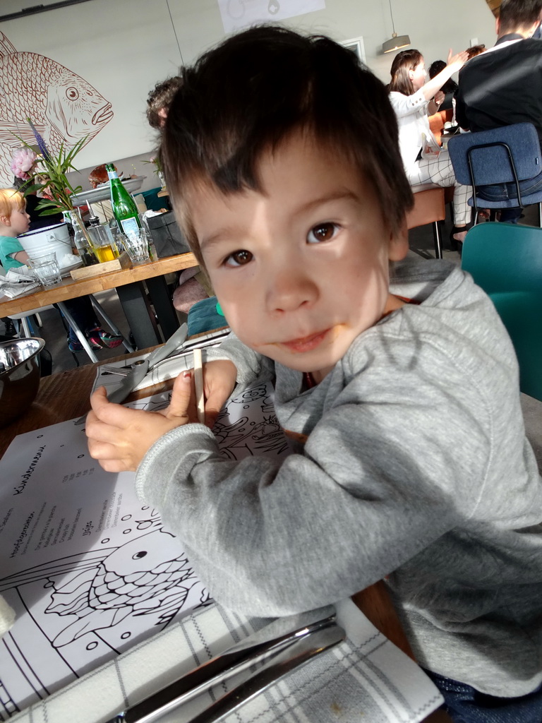 Max with a coloring page at the Seafarm restaurant