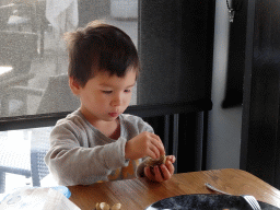 Max playing with seashells at the Seafarm restaurant