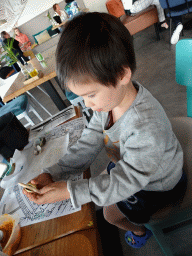 Max with a coloring page at the Seafarm restaurant