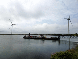 Boat and windmills at the Neeltje Jans island, viewed from the parking lot of the Proef Zeeland restaurant