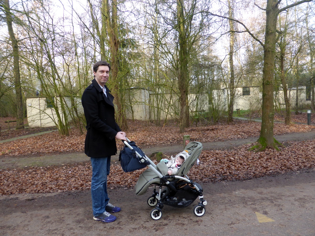 Tim with Max in a trolley on a road at the Center Parcs Kempervennen holiday park