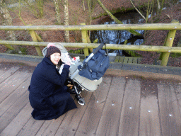 Miaomiao with Max in a trolley on a bridge over a river at the Center Parcs Kempervennen holiday park