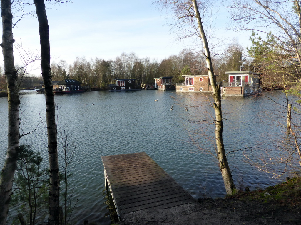 Holiday houseboats at the northeast side of the main lake at the Center Parcs Kempervennen holiday park