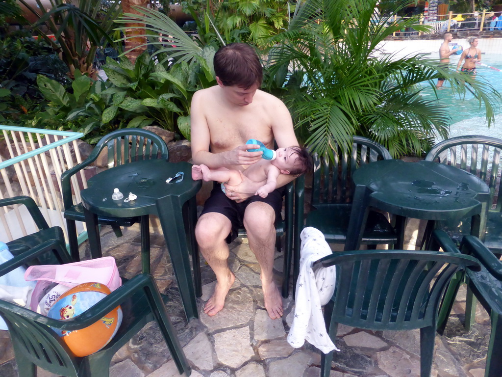 Tim giving Max a bottle at the Aqua Mundo swimming pool of the Center Parcs Kempervennen holiday park