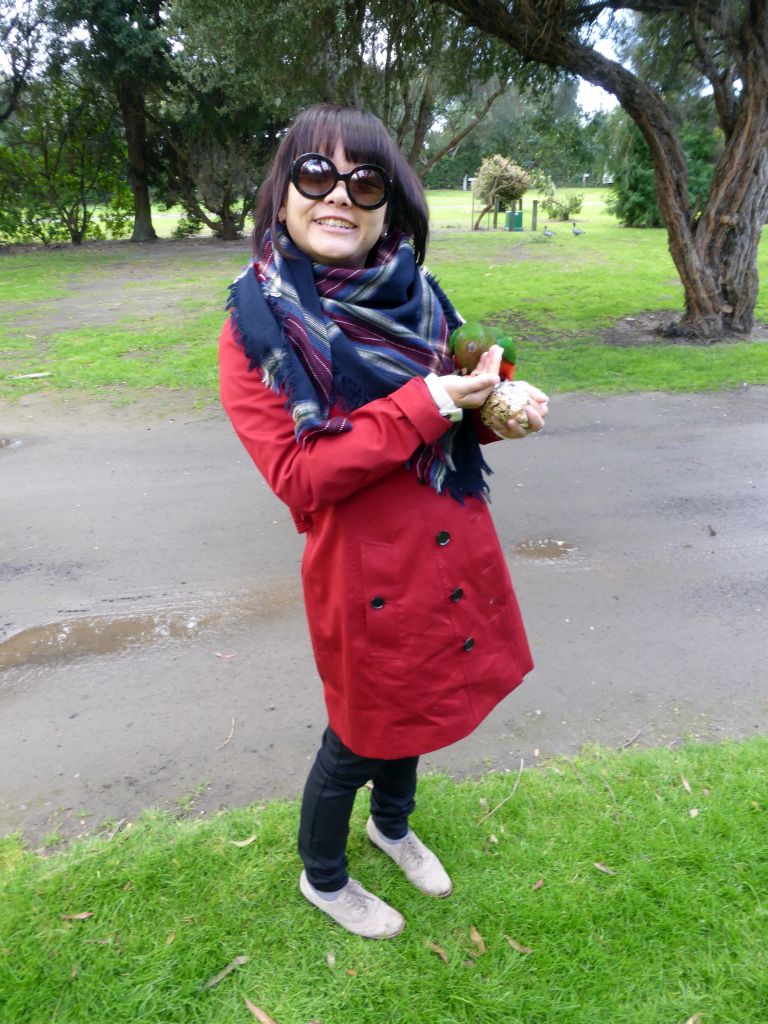 Miaomiao with an Australian king parrot at the Kennett River Holiday Park