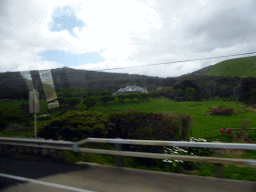 House and forested hills near Cape Patton, viewed from our tour bus on the Great Ocean Road