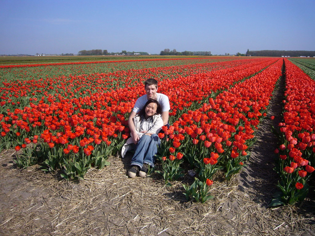 Tim and Miaomiao in a field with red tulips near Lisse