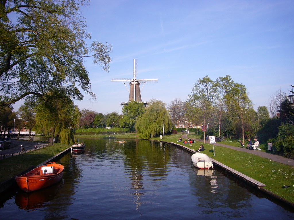 A windmill and boats in a canal near the Keukenhof park