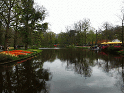 Central lake and flowers in a grassland near the Wilhelmina pavilion at the Keukenhof park