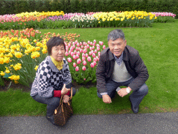 Miaomiao`s parents with pink, red, purple, white and yellow flowers near the northwest entrance of the Keukenhof park
