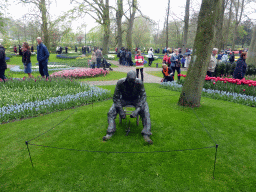 Statue and flowers north of the central lake at the Keukenhof park