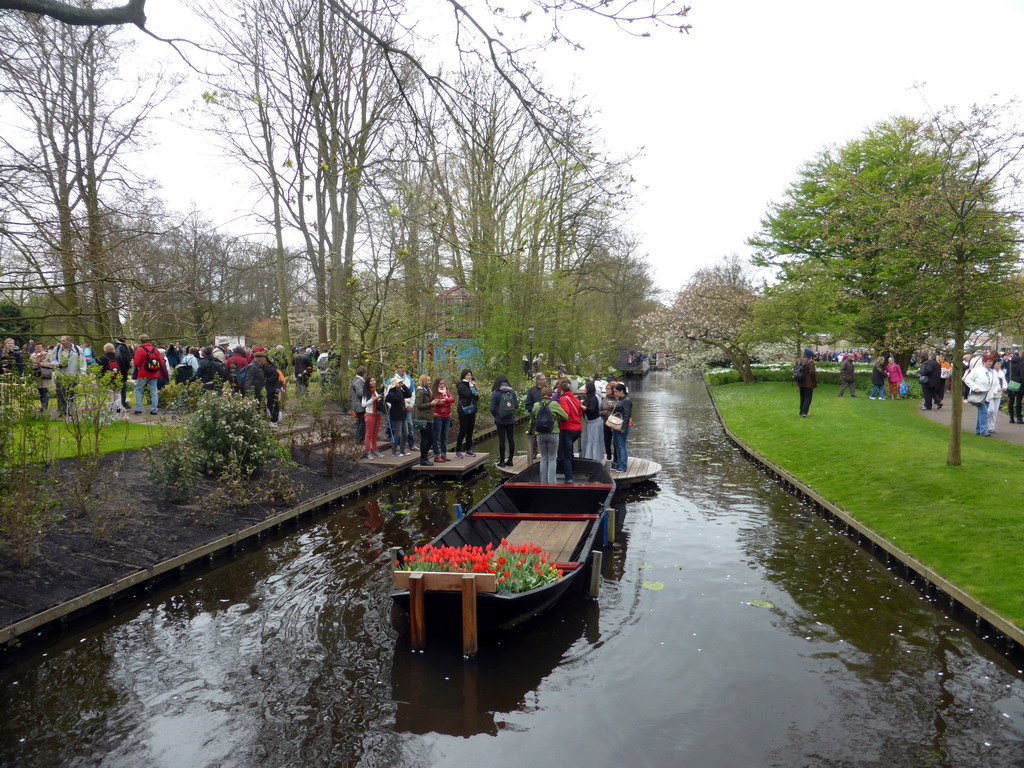 Boat in a canal, viewed from the bridge near the windmill at the Keukenhof park