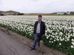 Miaomiao`s father with white, yellow and red flowers at flower fields at the south side of the Zilkerbinnenweg street at the village of De Zilk