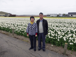 Miaomiao`s parents with white, yellow and red flowers at flower fields at the south side of the Zilkerbinnenweg street at the village of De Zilk