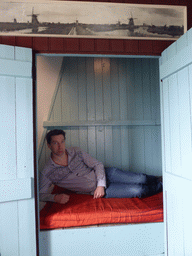 Tim in a closet-bed on the middle floor of the Museum Windmill Nederwaard