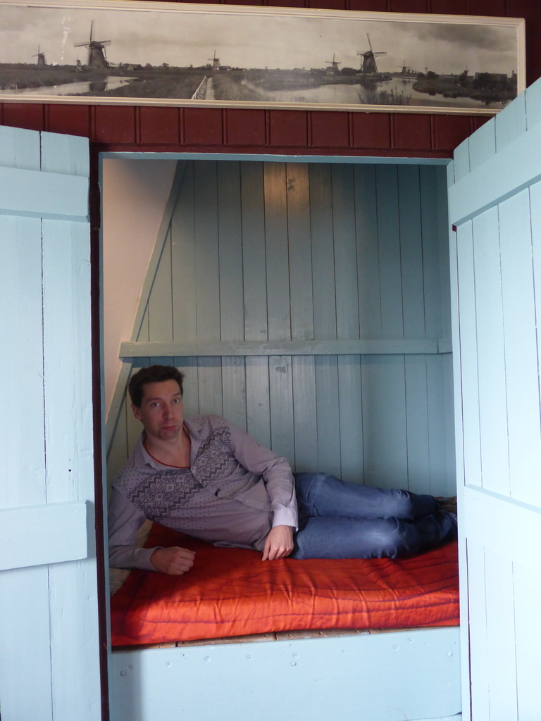 Tim in a closet-bed on the middle floor of the Museum Windmill Nederwaard