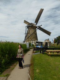 Miaomiao`s mother in front of the Museum Windmill Nederwaard and its ticket booth