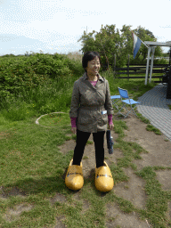 Miaomiao`s mother in wooden shoes near the Museum Windmill Nederwaard