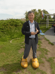 Miaomiao`s father in wooden shoes near the Museum Windmill Nederwaard