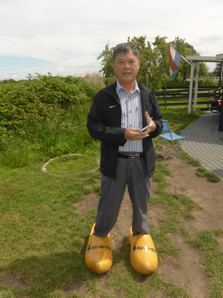Miaomiao`s father in wooden shoes near the Museum Windmill Nederwaard