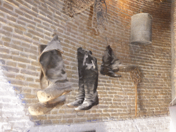 Boots hanging on the wall at the ground floor of the Museum Windmill Nederwaard